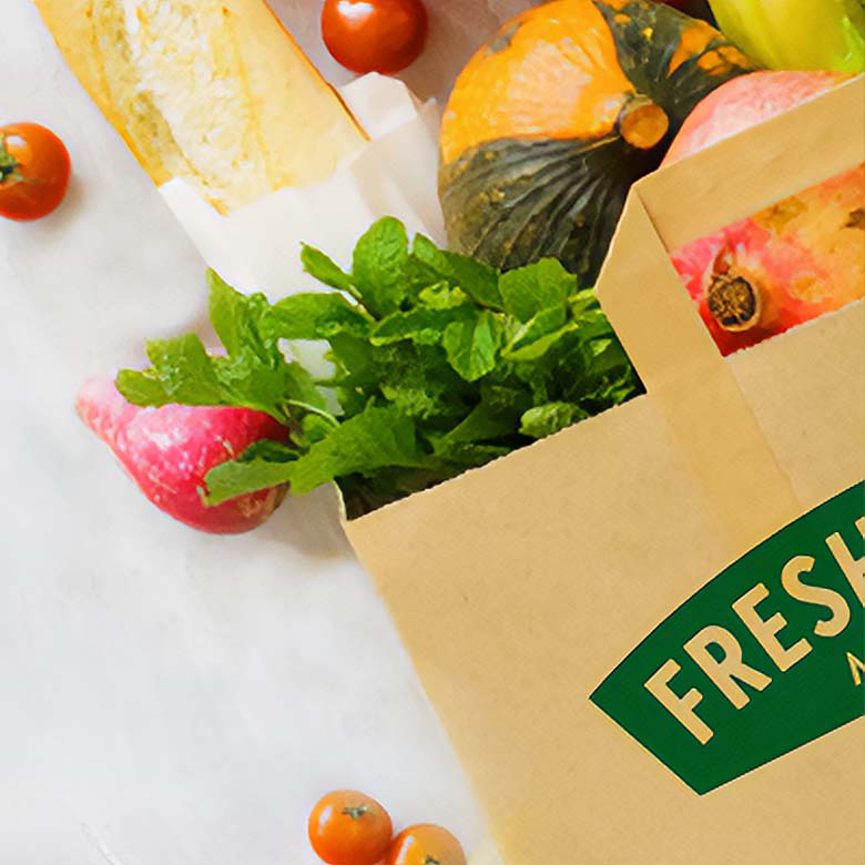 Fresh Thyme Market paper bag with fresh produce spilling out